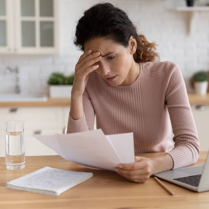 Stressed woman reviewing bills